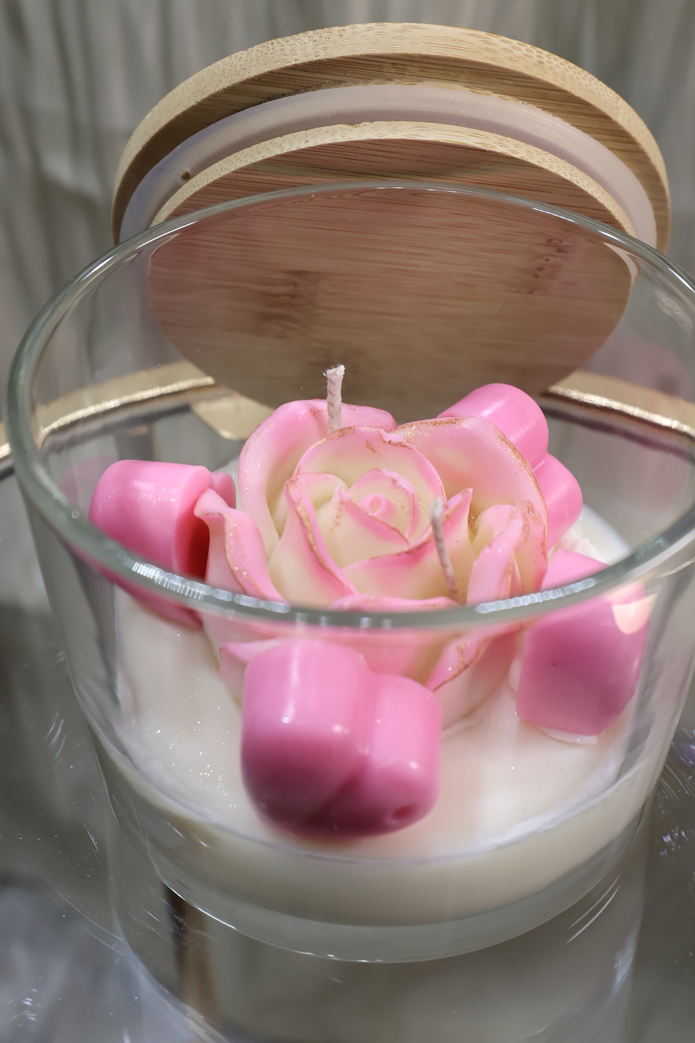 Handcrafted blush rose candle with soft pink sculpted wax petals in a glass jar