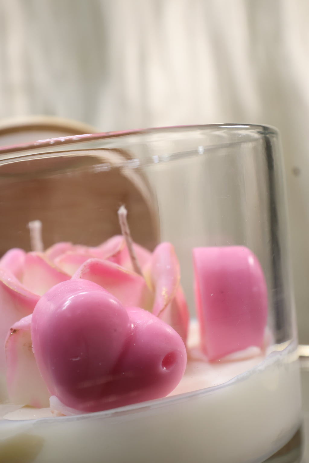 Handcrafted blush rose candle with soft pink sculpted wax petals in a glass jar