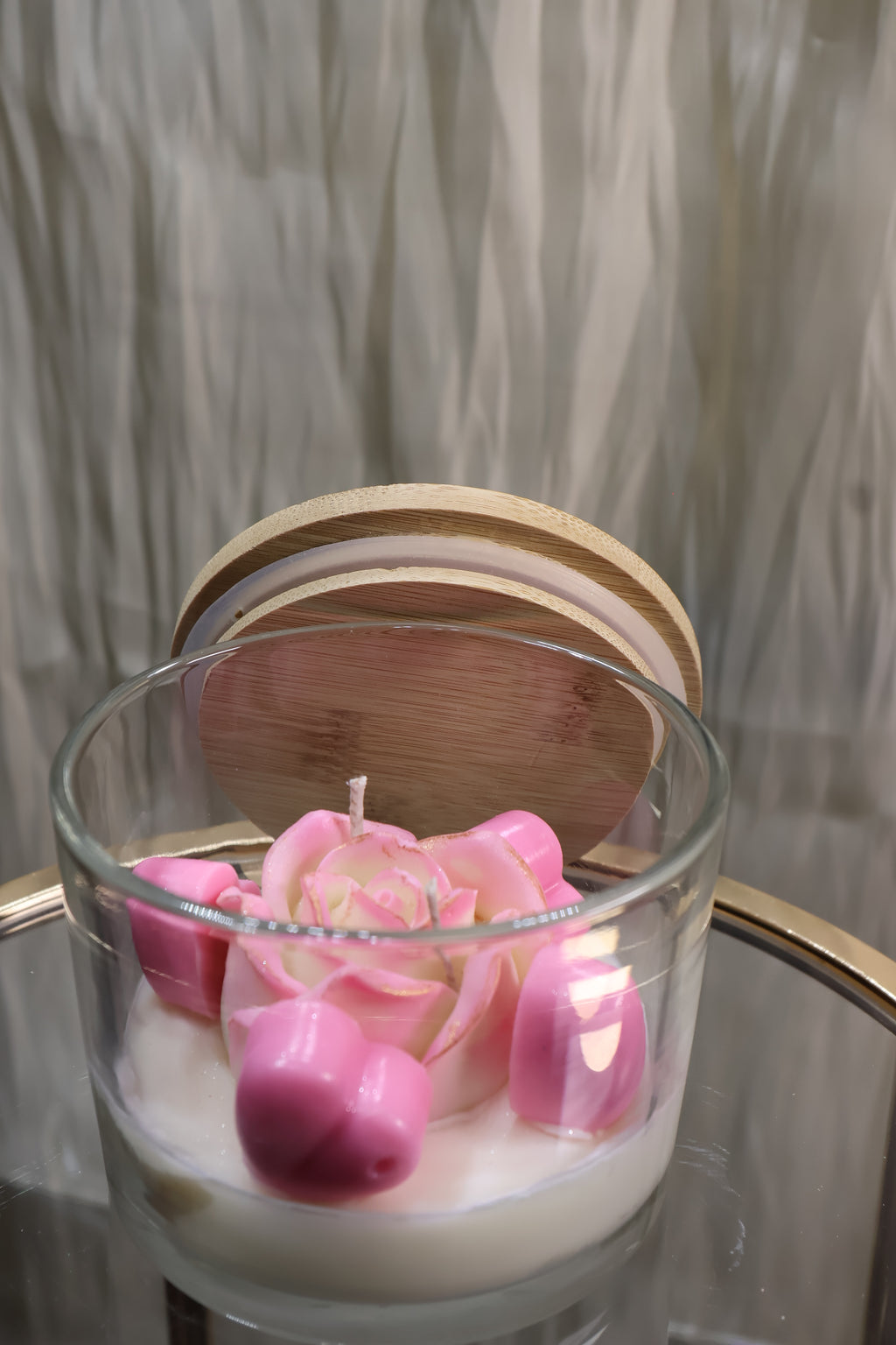 Handcrafted blush rose candle with soft pink sculpted wax petals in a glass jar
