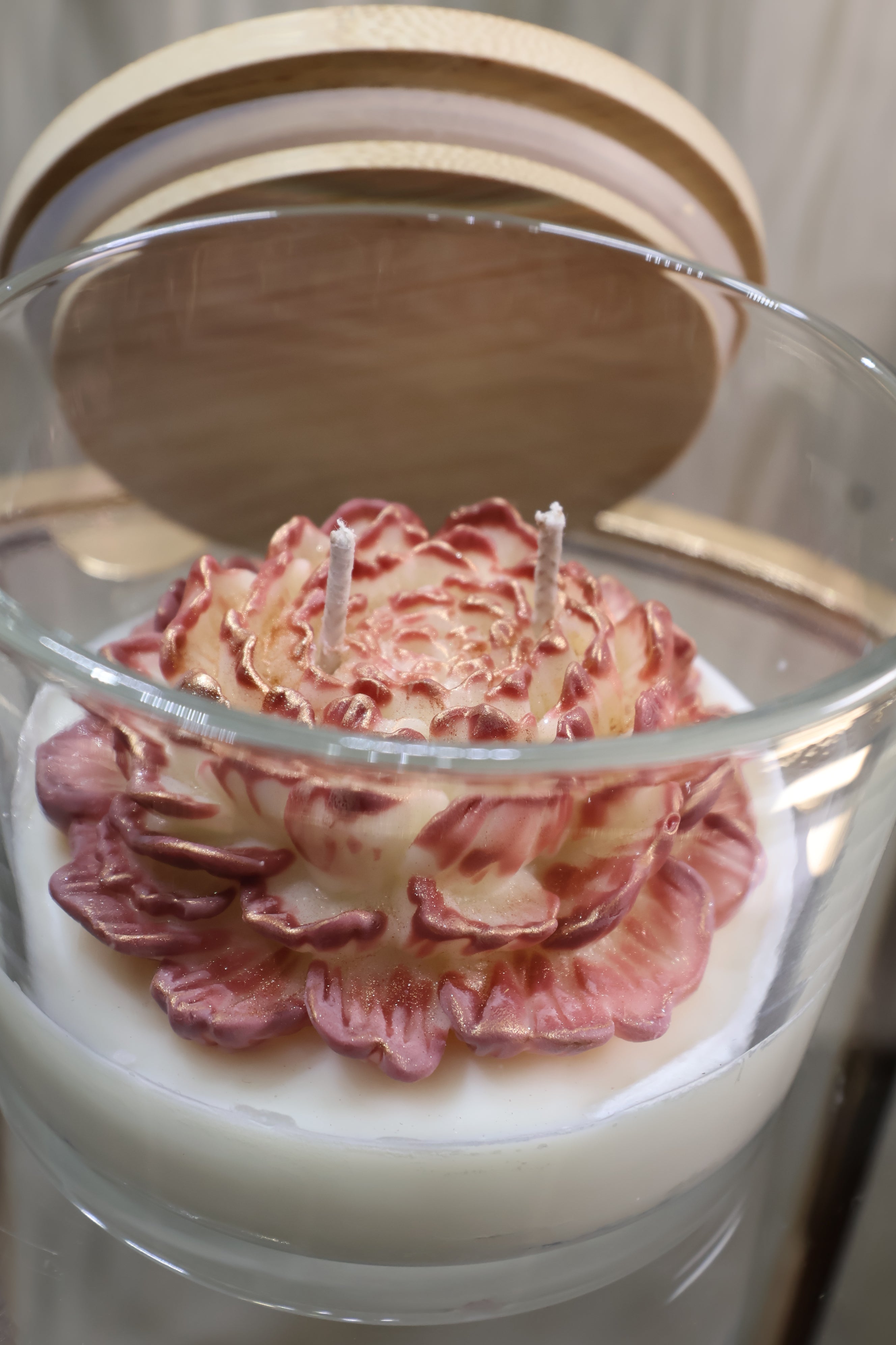 Handcrafted champagne bloom rose candle with sculpted wax petals in a glass jar