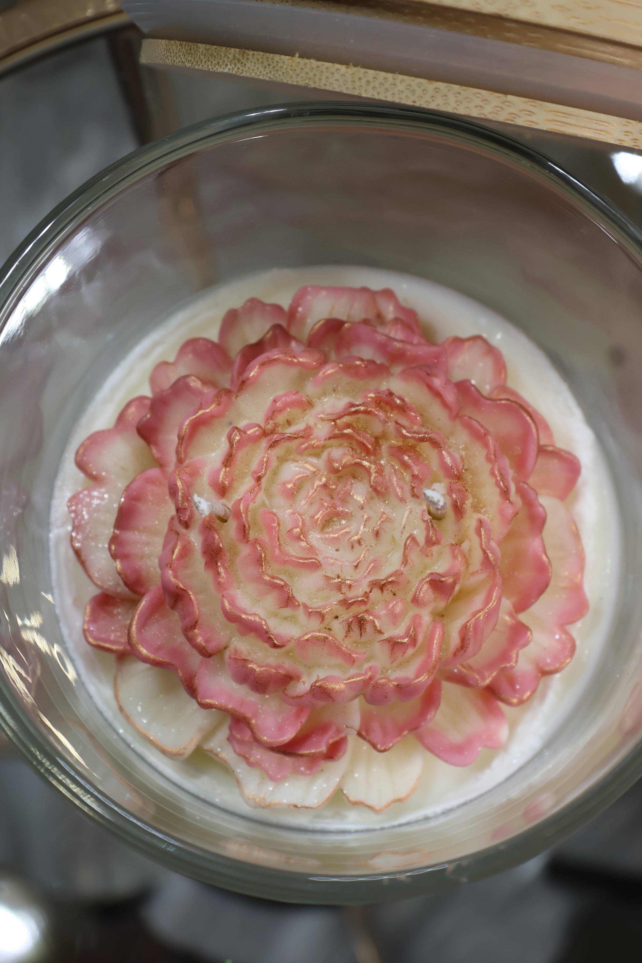 Handcrafted champagne bloom rose candle with sculpted wax petals in a glass jar