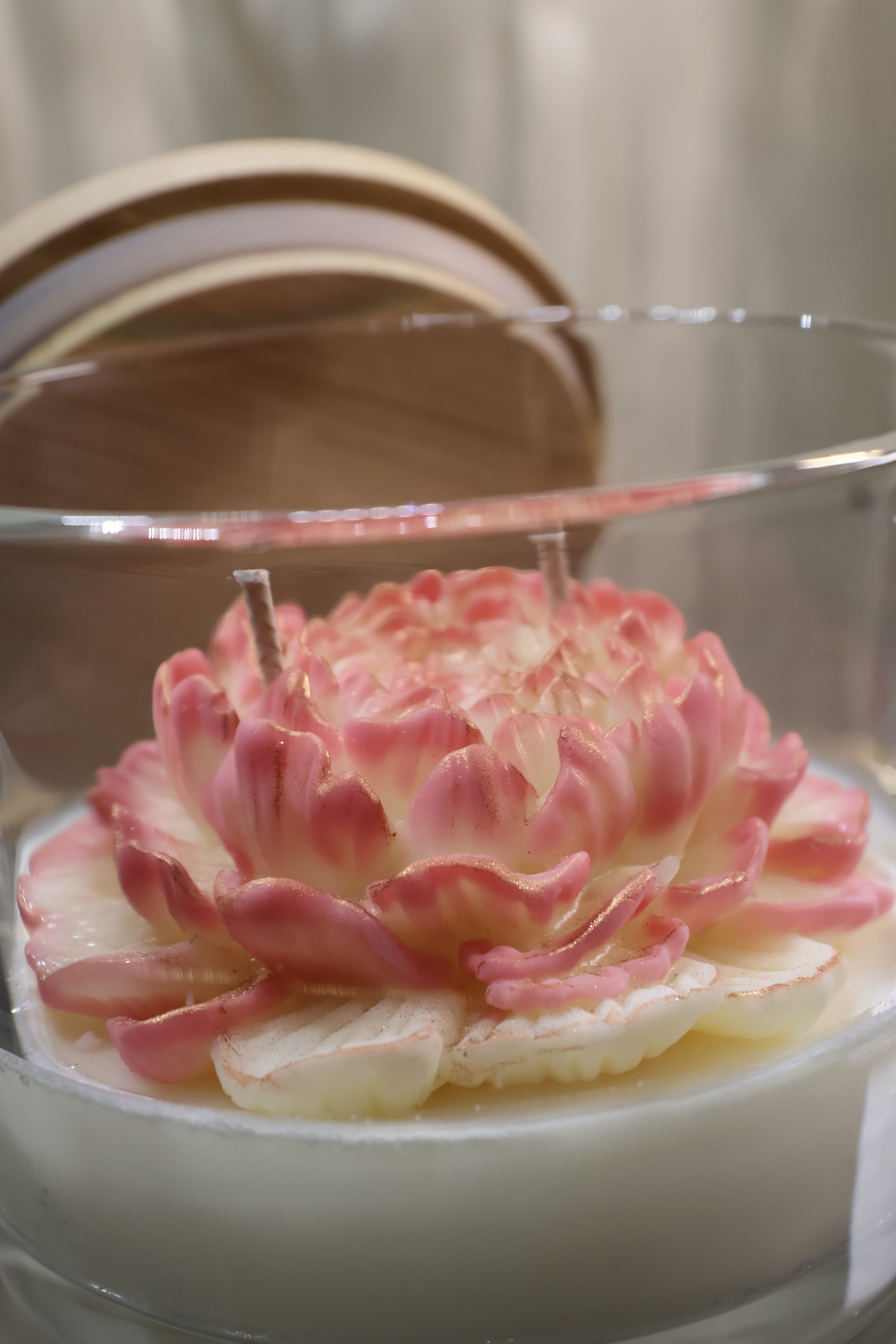 Handcrafted champagne bloom rose candle with sculpted wax petals in a glass jar