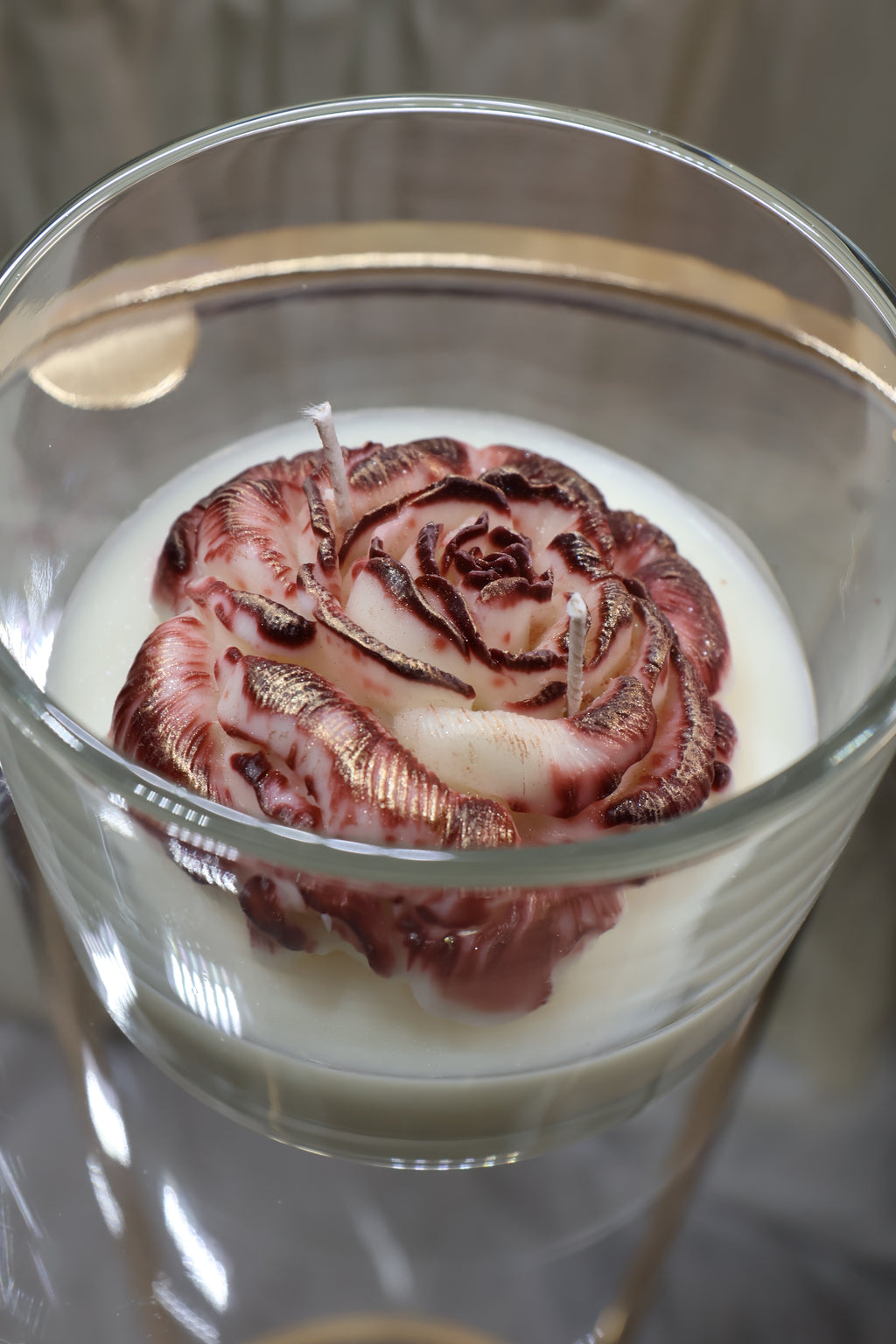 Handcrafted crimson veil rose candle with deep red sculpted wax petals in a glass jar