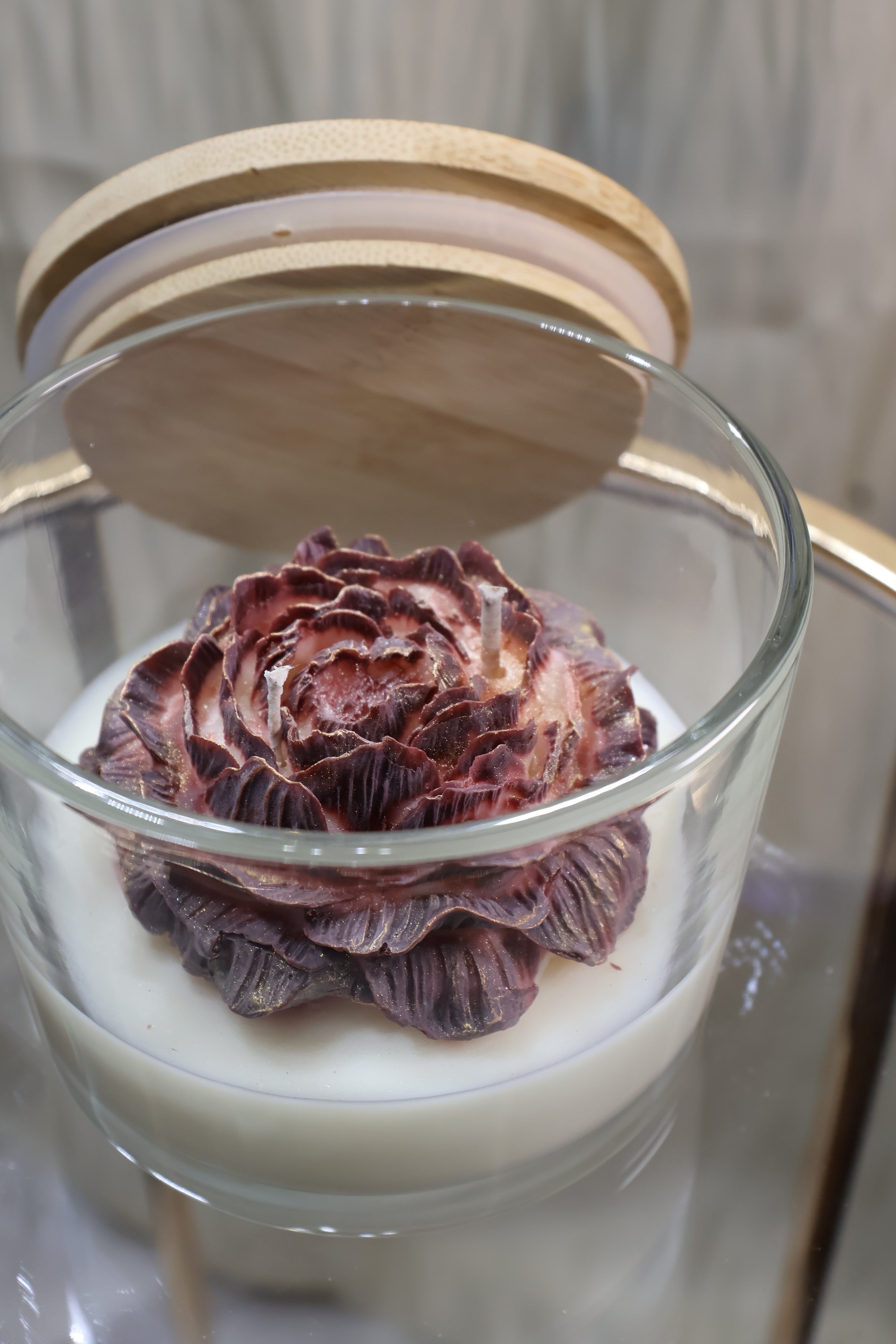 Handcrafted midnight rose candle with sculpted burgundy wax petals in a glass jar
