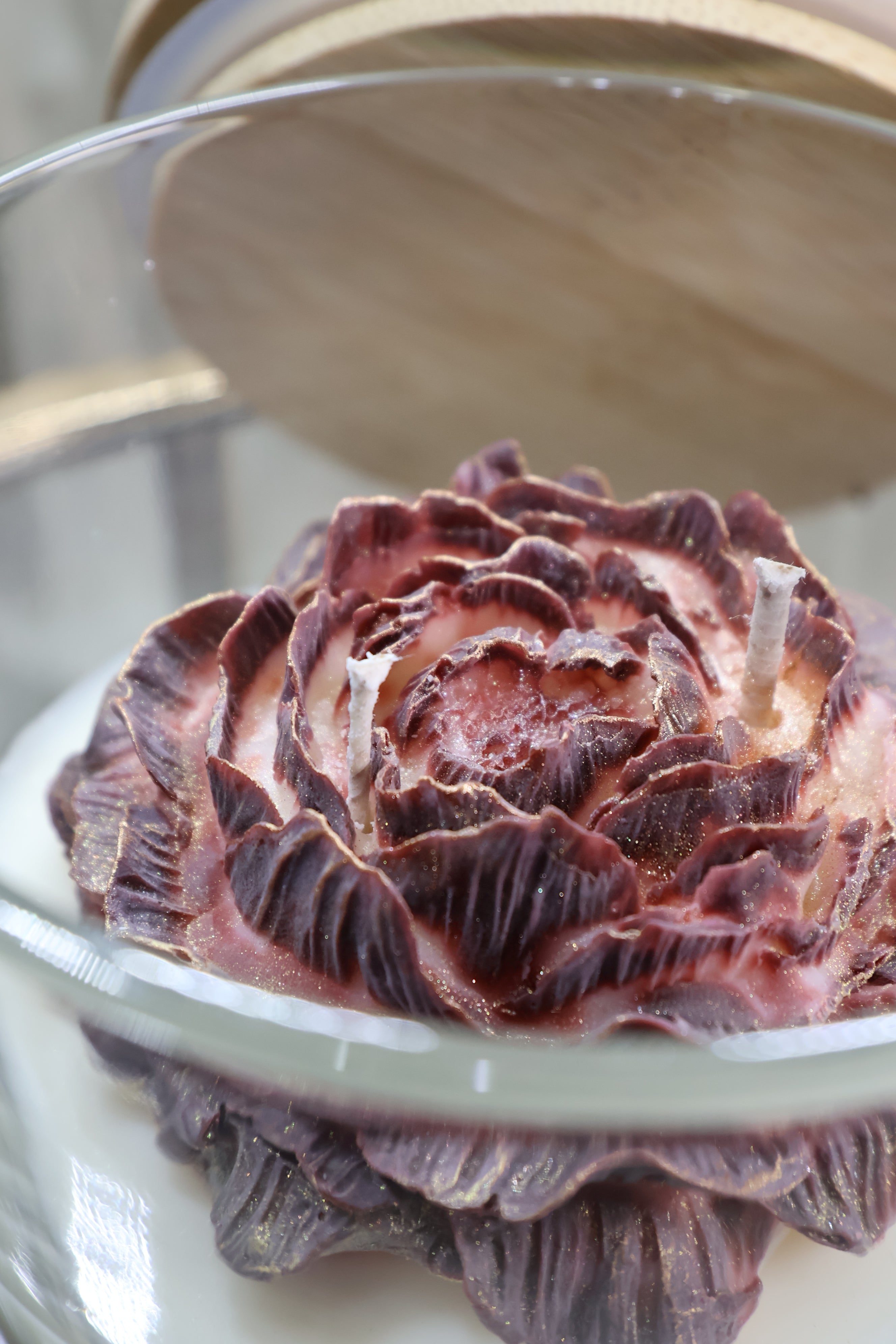 Handcrafted midnight rose candle with sculpted burgundy wax petals in a glass jar