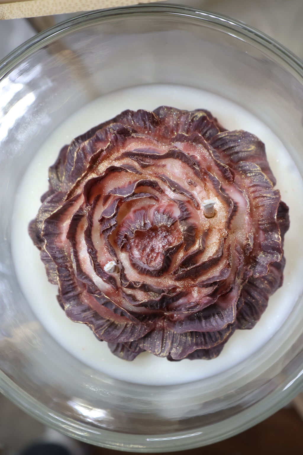 Handcrafted midnight rose candle with sculpted burgundy wax petals in a glass jar