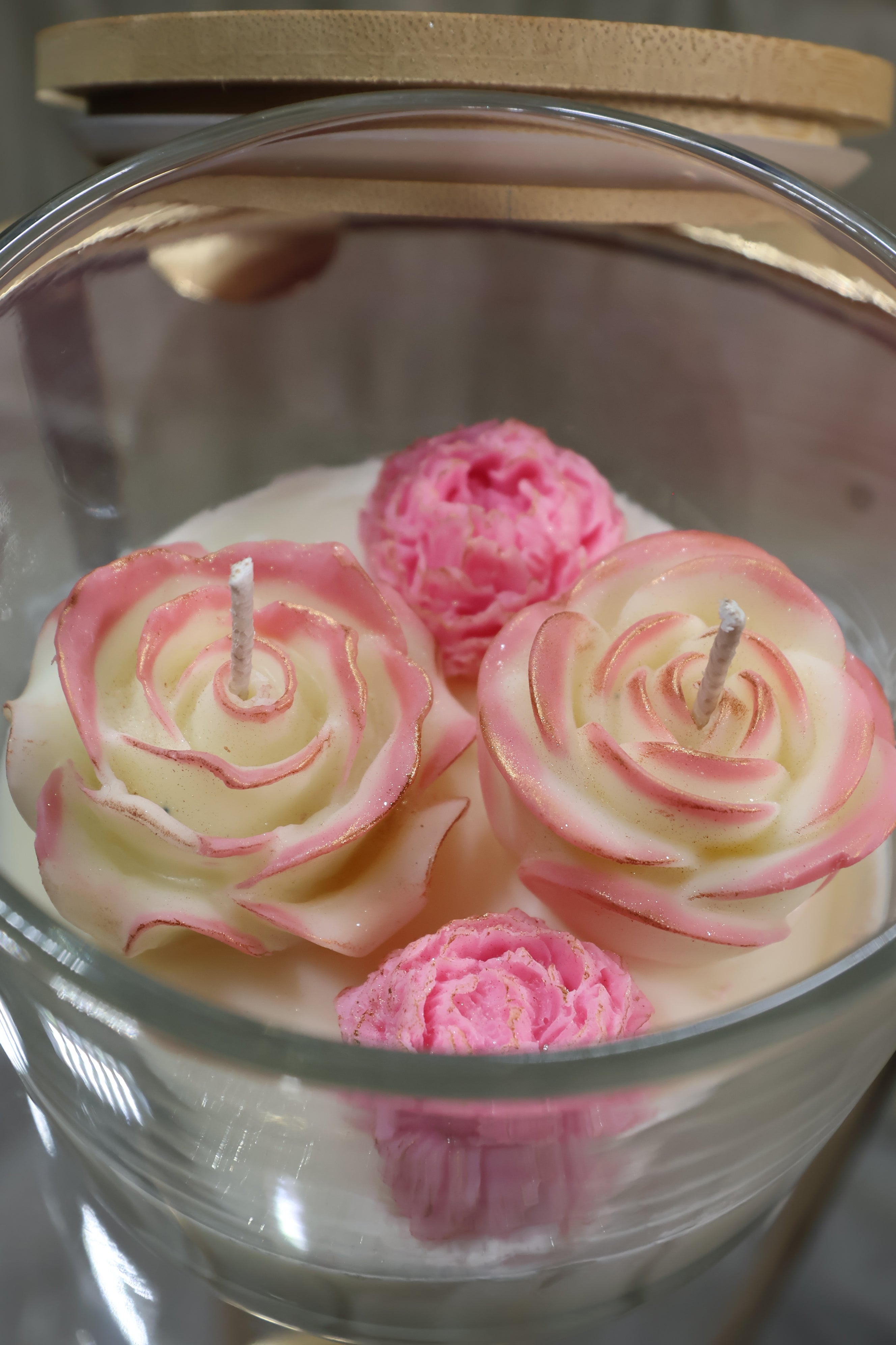 Handcrafted quartet of love rose candle with four sculpted wax flowers in a glass jar