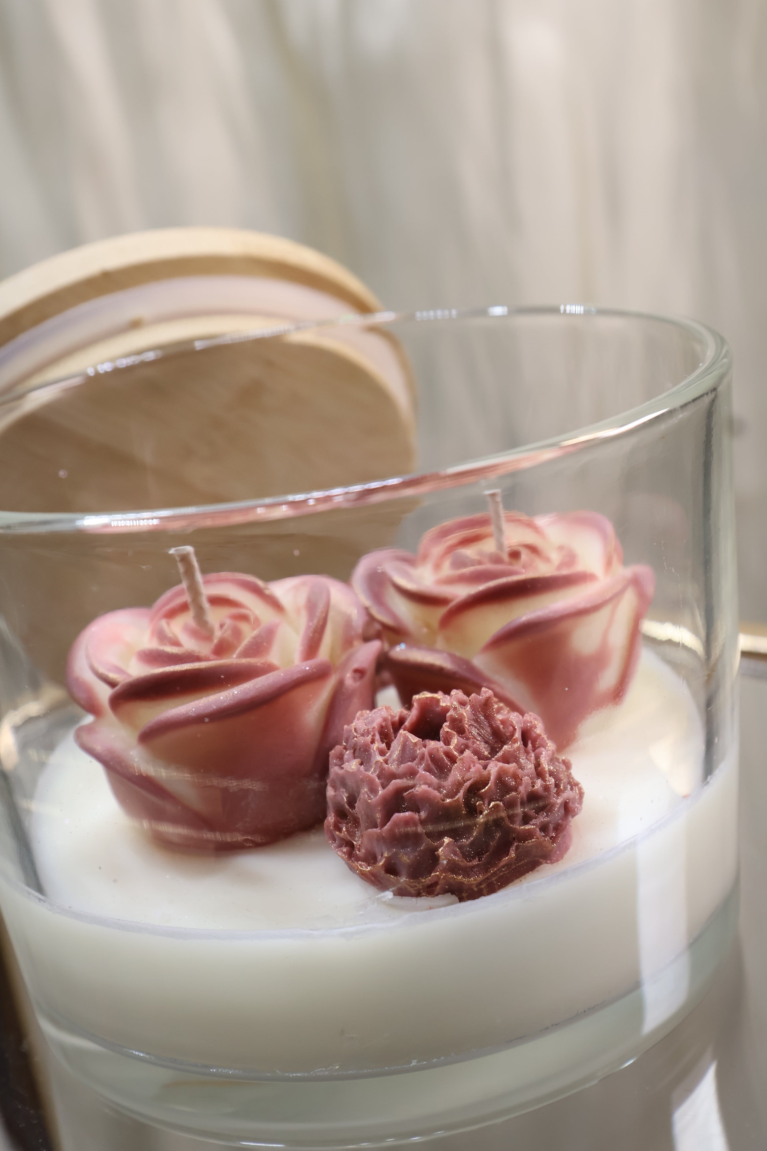 Handcrafted rosé duet rose candle with two sculpted wax flowers in a glass jar