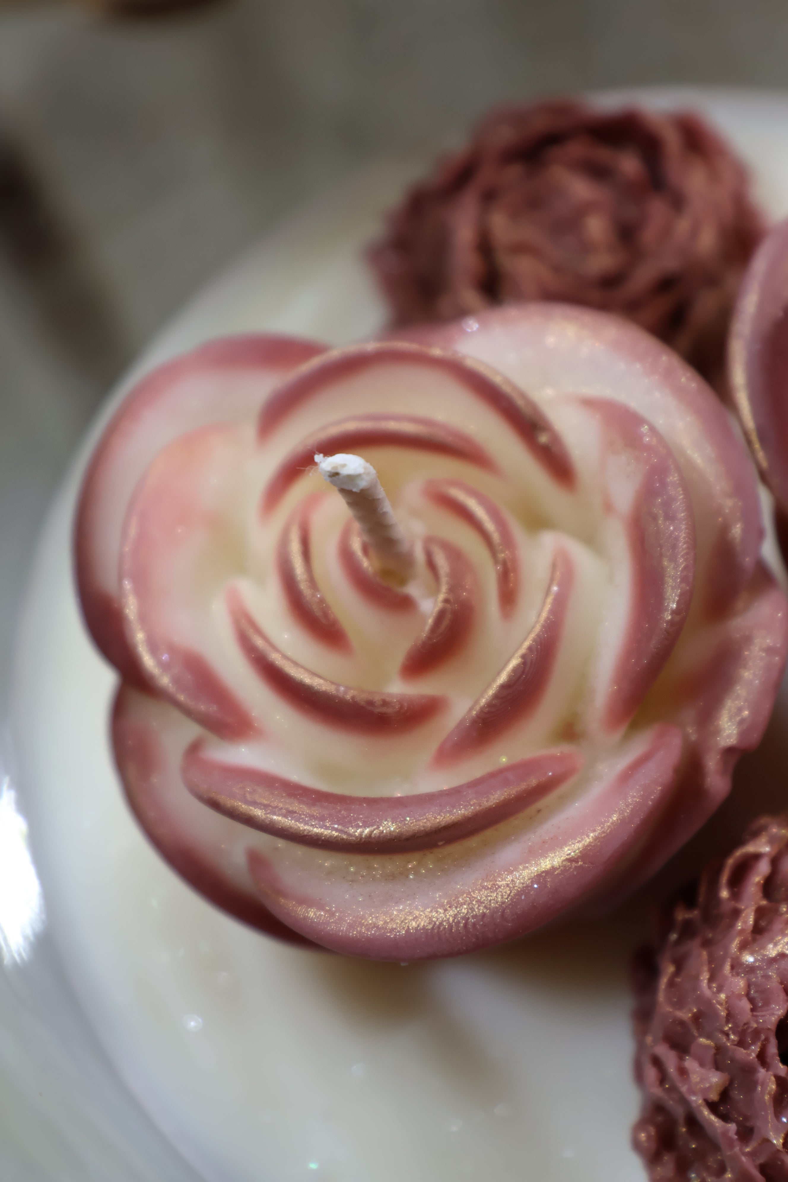 Handcrafted rosé duet rose candle with two sculpted wax flowers in a glass jar