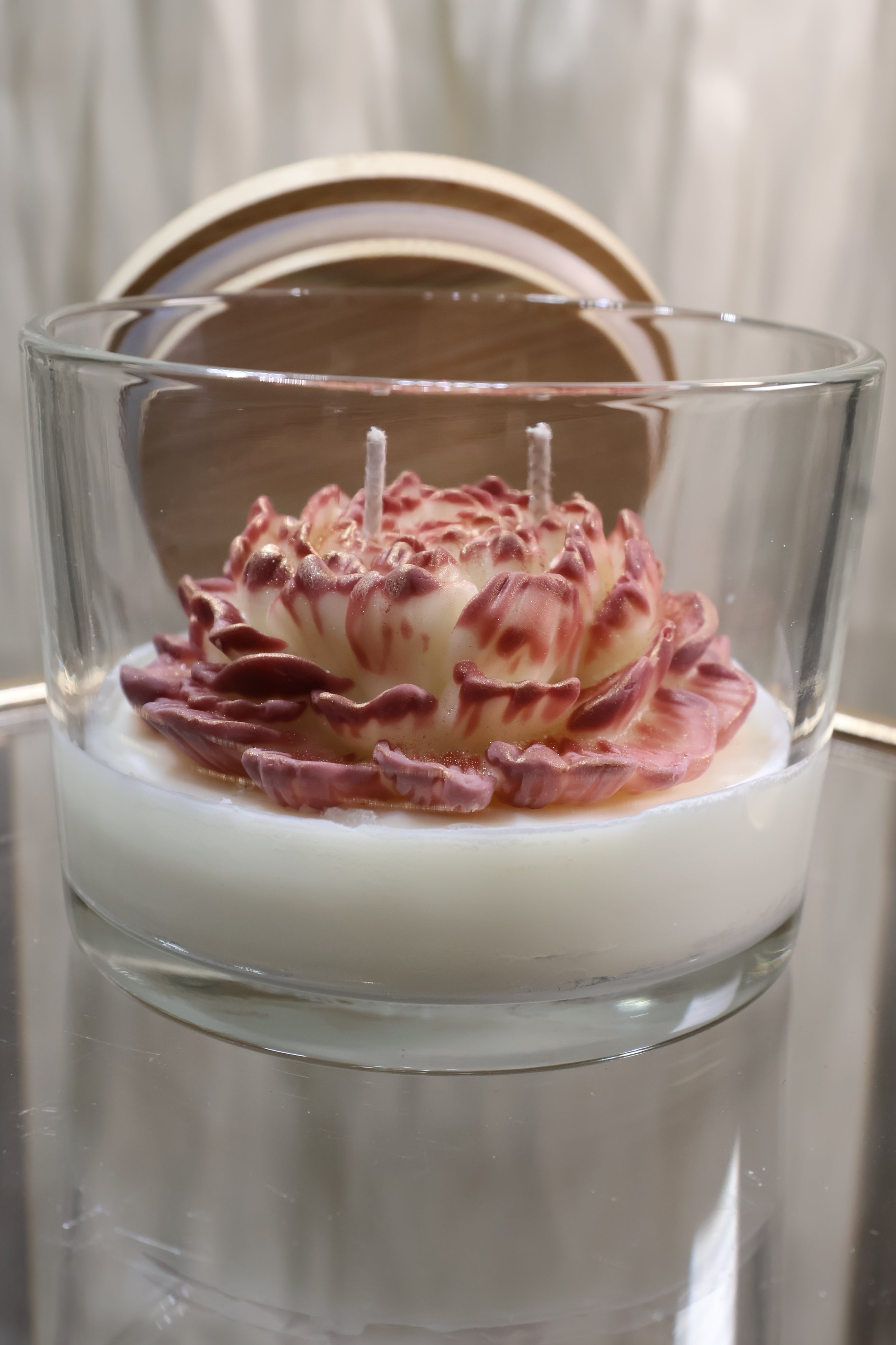 Handcrafted rosewood embrace rose candle with sculpted wax petals in a glass jar