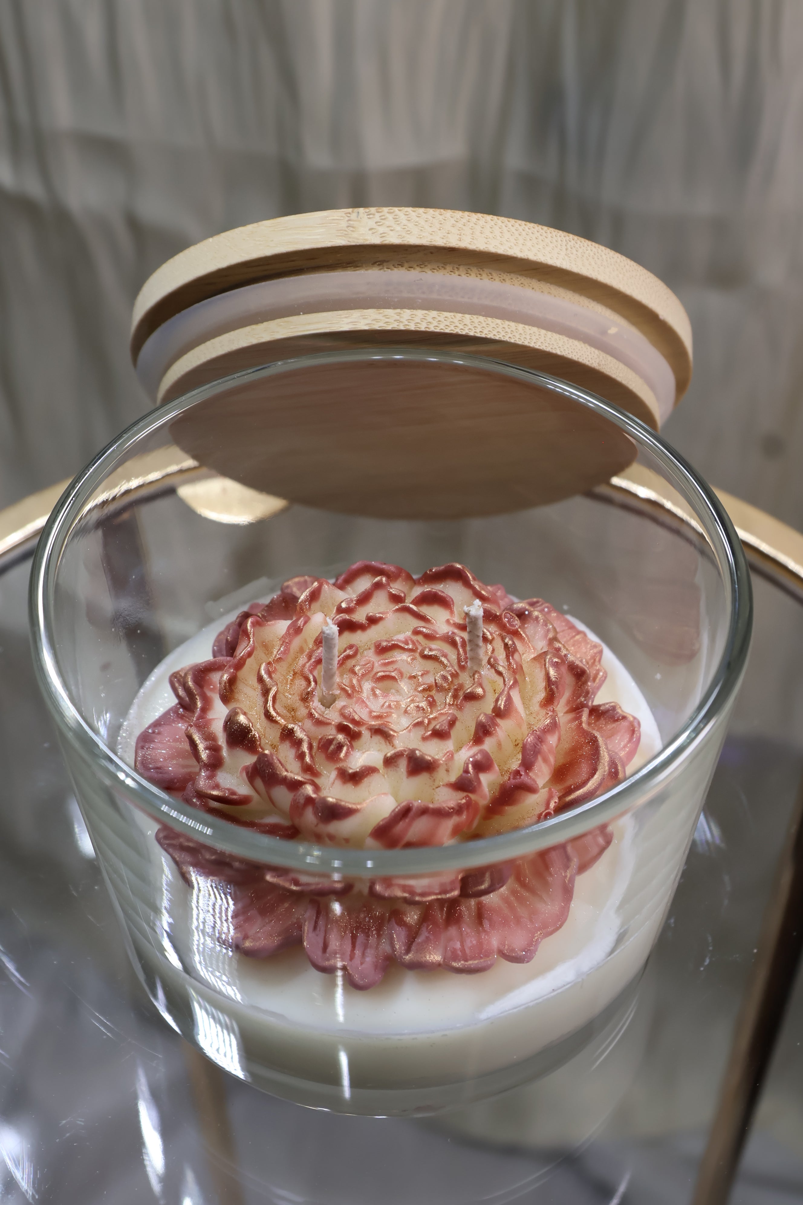 Handcrafted rosewood embrace rose candle with sculpted wax petals in a glass jar